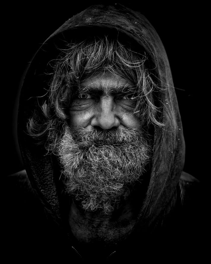 services-03 Emotive black and white portrait of an elderly man with a rugged appearance.